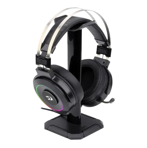 A black over-ear gaming headset displayed on a matching black charging stand. The headset features a circular side badge with a stylized logo and a multicolor RGB ring of light, set against a plain white background.