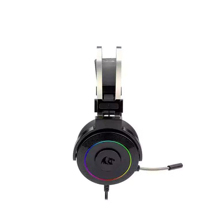 Black over-ear gaming headphones with a silver headband support, a circular RGB LED ring on the ear cup, and an attached microphone, shown on a white background with a Sigma Computer logo in the top-left corner.