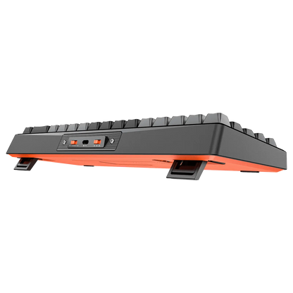 Side view of black mechanical keyboard with orange underside lighting